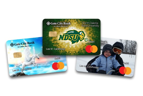 an assortment of three personalized debit cards from Gate City Bank, including a unicorn, NDSU and family photo design