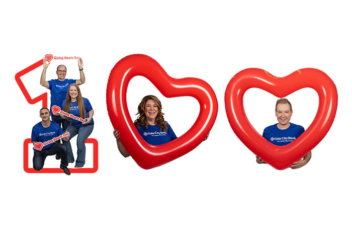 Gate City Bank team members and giant heart shaped balloons form the image of the number 100