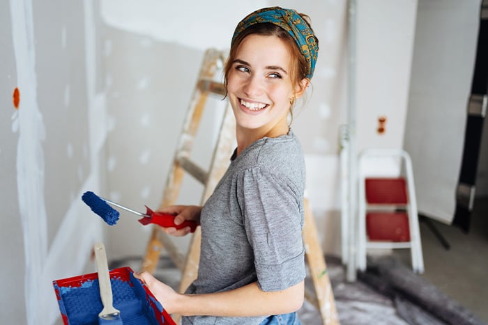 A young woman works on her Bismarck, ND, home, thanks to a loan through Gate City Bank’s home improvement program.