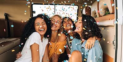 four happy friends in a cloud of confetti, celebrating Gate City Bank promotions in honor of 100 years of better banking