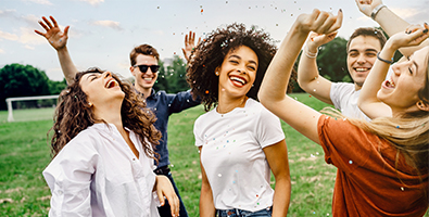 laughing group of young people dance in the park on a sunny day and celebrate special offers from gate city bank  