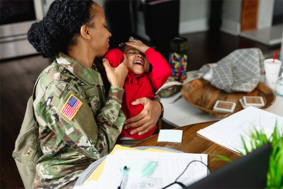 military mom plays with her son child at their home financed with a v.a. loan through gate city bank