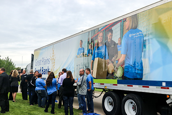 community members stand near the truck Gate City Bank gave to Great Plains Food Bank