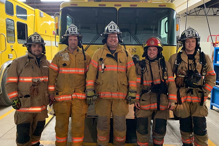 Wahpeton firefighters pose for a picture while wearing their new protective helmets