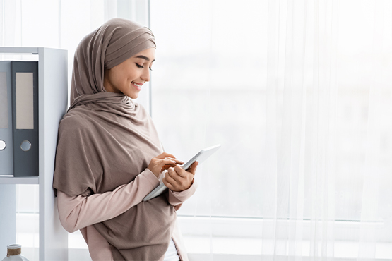 happy businesswoman uses business relationship savings account with tablet