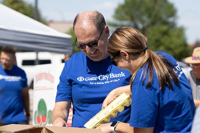 Bank President and CEO Kevin Hanson smiles while volunteering at West Fargo Eats with the Gate City Bank leadership team