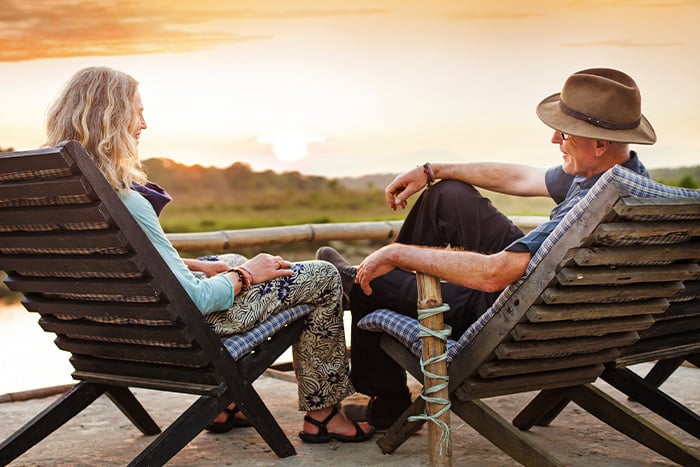 Senior couple relaxing at sunset by their lake home, purchased with a Gate City Bank mortgage loan in Alexandria, Minnesota 