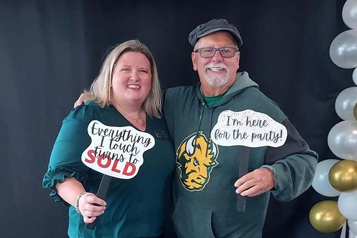 Long-time customer Mark Rye of Moorhead, MN, posing for a photo in NDSU gear with his niece