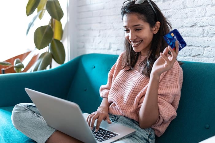 smiling woman uses her checking account to easily transfer to her savings account with Simply Save at Gate City Bank