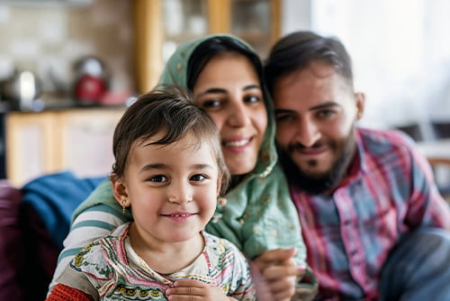 Candid photo of Syrian family in the living room of their new home in Grand Forks, ND