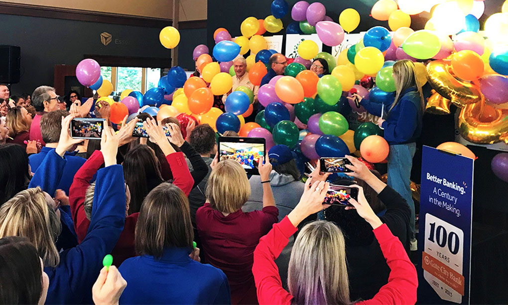 balloons fall on stage and a crowd erupts in cheers as CCRI is revealed as the winner of Gate City Bank’s one-hundred-thousand-dollar-Giving Hearts Day donation