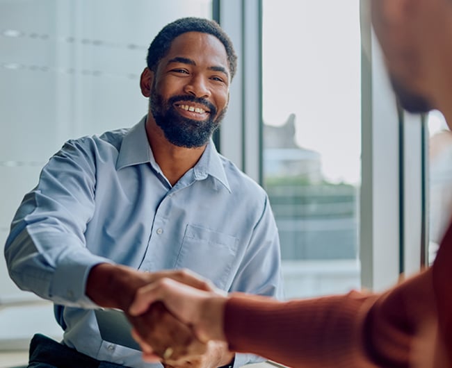 Local business owner shaking hands with a Gate City Bank Commercial Relationship Officer in Elk River, Minnesota.