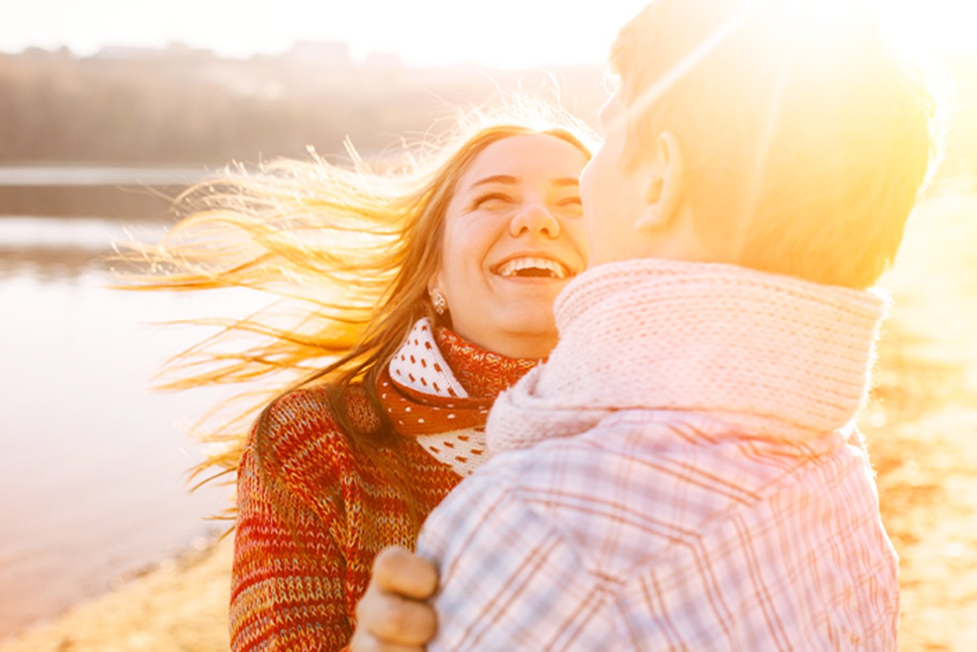 couple smiles together on sunny day near lake after experiencing Gate City Bank benefits