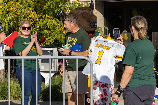 Gate City Bank team members celebrate as a lucky Bison fan takes home an NDSU jersey.
