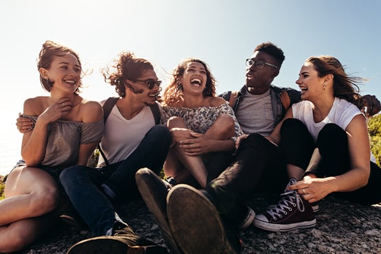 young group of friends sits together and enjoys peace of mind after avoiding fraud