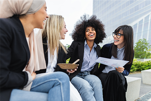 A group of business women enjoy time outside after setting up automatic sweeps with gate city bank