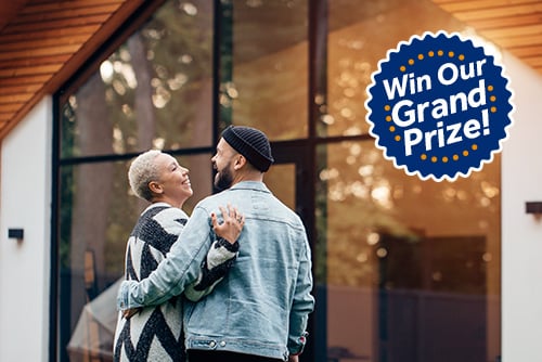 Couple outside new home in Fargo, North Dakota, after winning a prize from Gate City Bank during the Fall Parade of Homes.