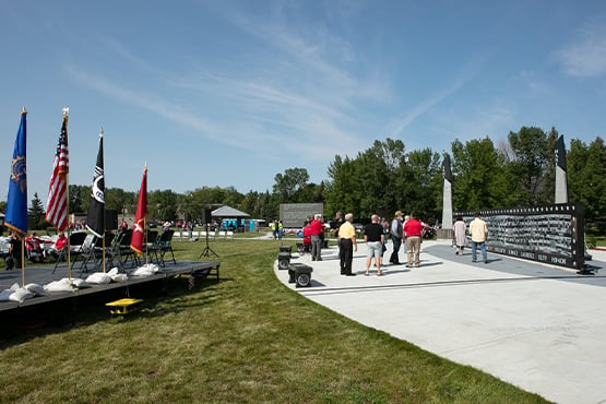 community members tour Veterans Memorial Park in Grand Forks during grand opening