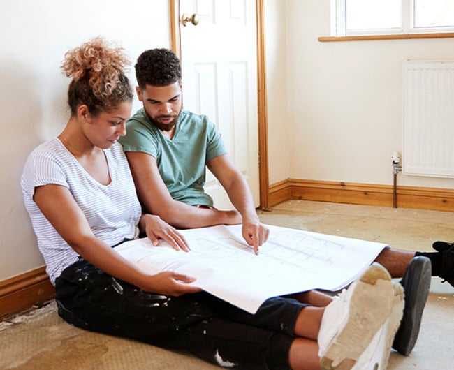 Young married couple reviewing their renovation plan after getting a home equity loan from Gate City Bank in Moorhead, MN.