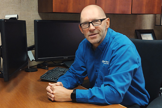 Darryl Jorgenson sits at his work desk at Gate City Bank in Grand Forks ND