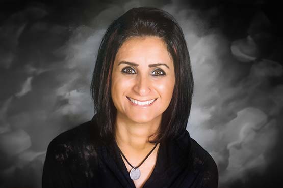 Nadir Muhammed smiles for the camera in her professional headshot