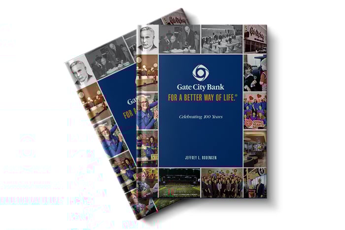 Two editions of Gate City Bank’s history book, For a Better Way of Life®, are placed together on a white background