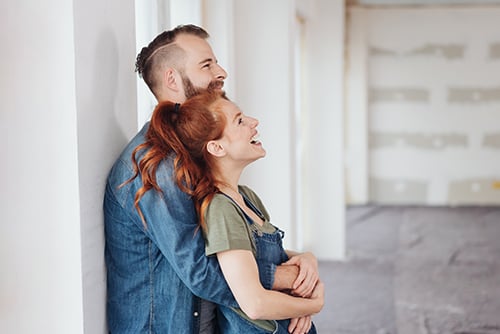 laughing newlyweds making house repairs and renovations, thanks to a Gate City Bank home improvement loan