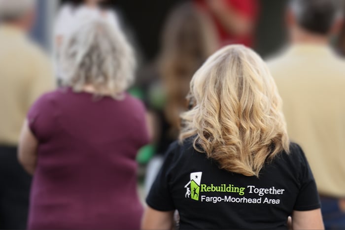 community members look on during a low-income housing grand opening in Fargo ND