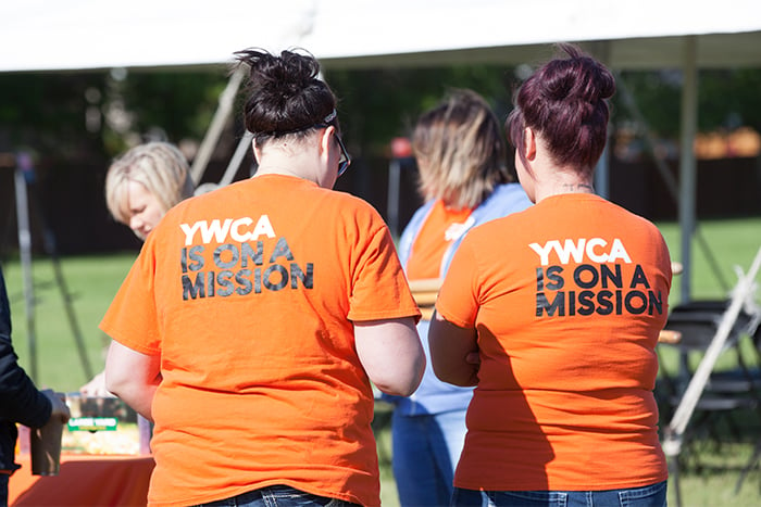 YWCA team members and Gate City Bank volunteers on a sunny day, working together to help women and children in Fargo Moorhead 