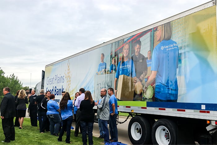 Gate City Bank staff and community members gather near Great Plains Food Bank truck
