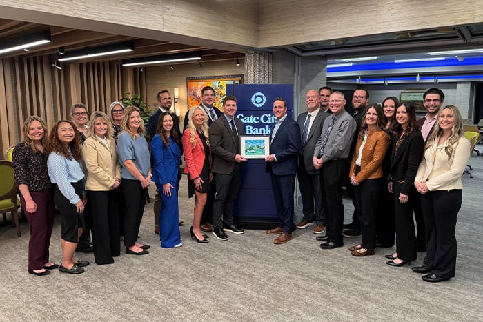 Gate City Bank mortgage lenders pose with the Champion of Affordable Housing Award at the bank’s headquarters in Fargo, ND.