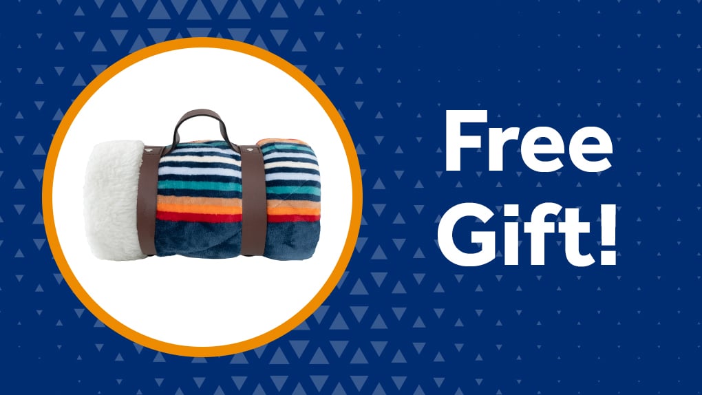 Striped velvet and sherpa throw blanket, available as a free gift for referrals and new customers