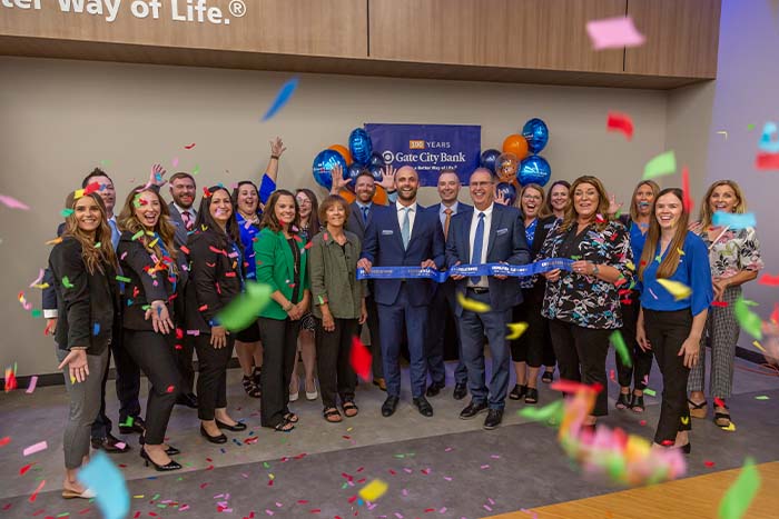 Surrounded by confetti, ecstatic team members and Elk River, MN, partners celebrate after Gate City Bank’s ribbon-cutting ceremony