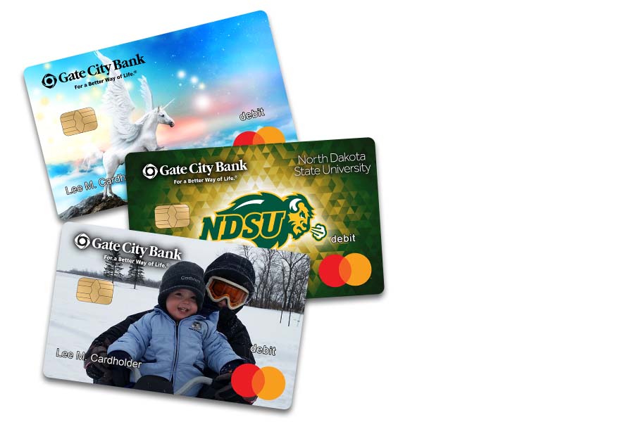 an assortment of three personalized debit cards from Gate City Bank, including a unicorn, NDSU and family photo designs