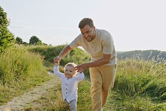 A little boy and his father play at a park in rural Minnesota after visiting their local Gate City Bank