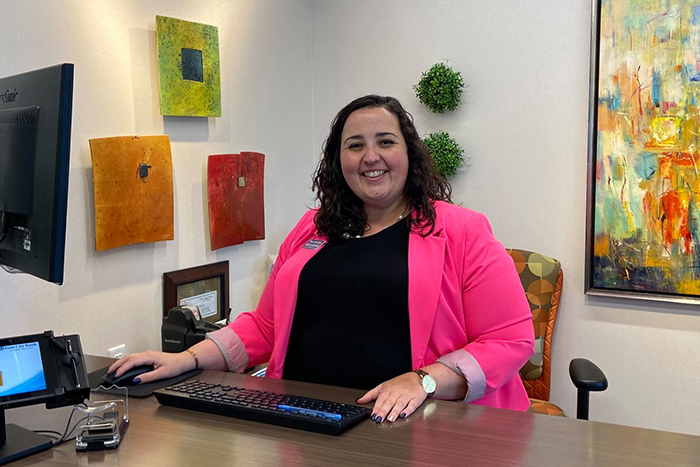 Megan Pflipsen smiles from her desk at Gate City Bank in Sauk Rapids Minnesota