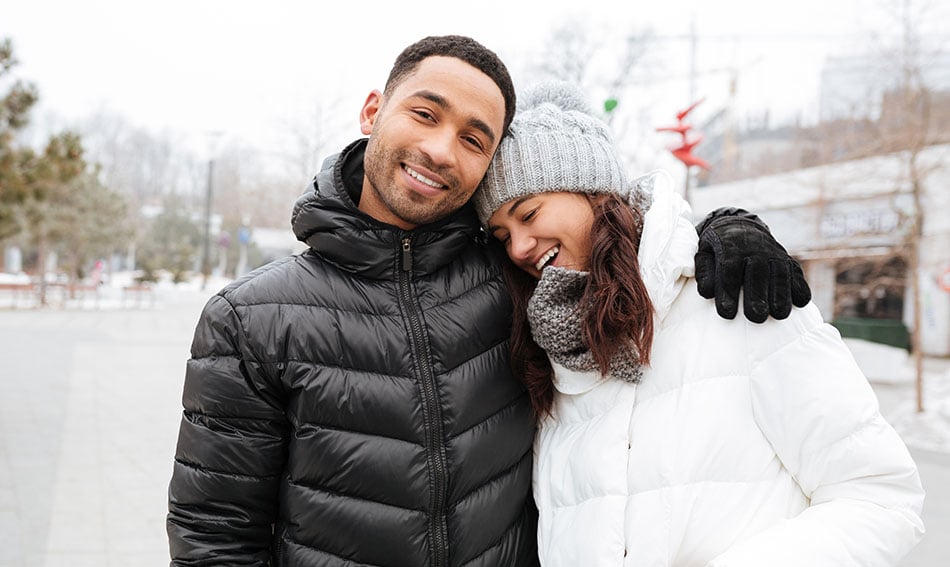 Sweet young couple hugging and laughing in downtown Bismarck after opening their checking accounts
