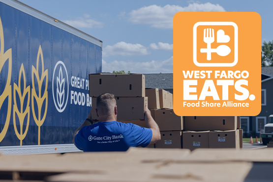 Gate City Bank team member volunteer hauls boxes for West Fargo Eats near truck