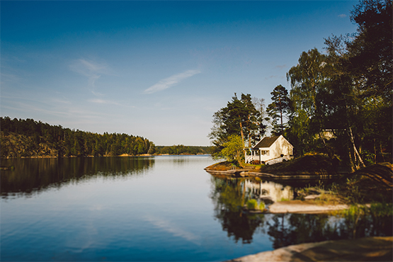 quaint lake home sits perched in the sunshine after being financed with gate city bank