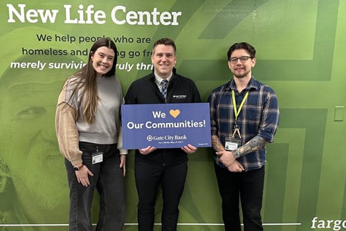 A Gate City Bank team member gives a mortgage donation to New Life Center, a Fargo ND homeless shelter.