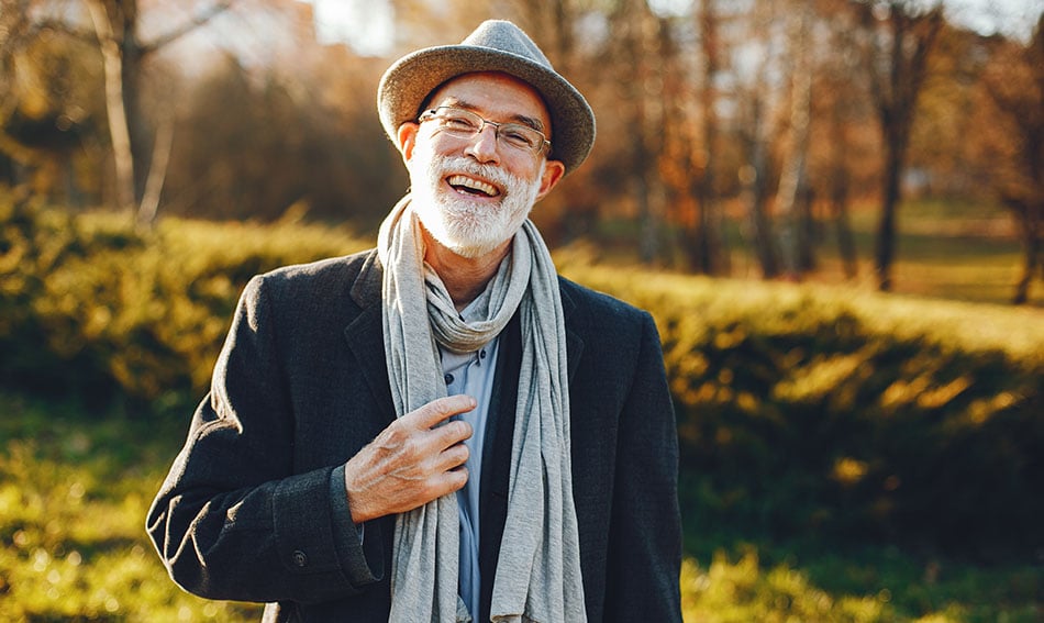 Cheerful senior business owner, walking to meet his business banker in downtown Grand Forks on a sunny autumn day 