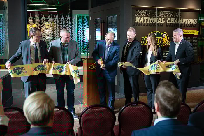 Gate City Bank and NDSU leadership team members cut a ribbon to celebrate the opening at the new Coach’s Office