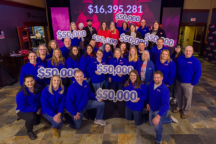 Gate City Bank & Rape & Abuse Crisis Center gather after the charity won the bank’s $50K Giving Hearts Day nomination contest