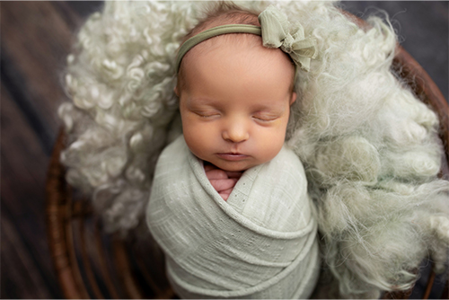 a heartwarming picture of sleeping newborn baby girl Reagan to go on custom debit card