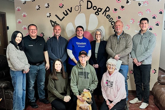 Gate City Bank employees give a donation to 4 Luv of Dog Rescue through the bank&rsquo;s charity gift program for homebuyers