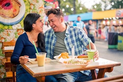 Guatemalan couple sitting together at a table at the downtown Fargo street fair