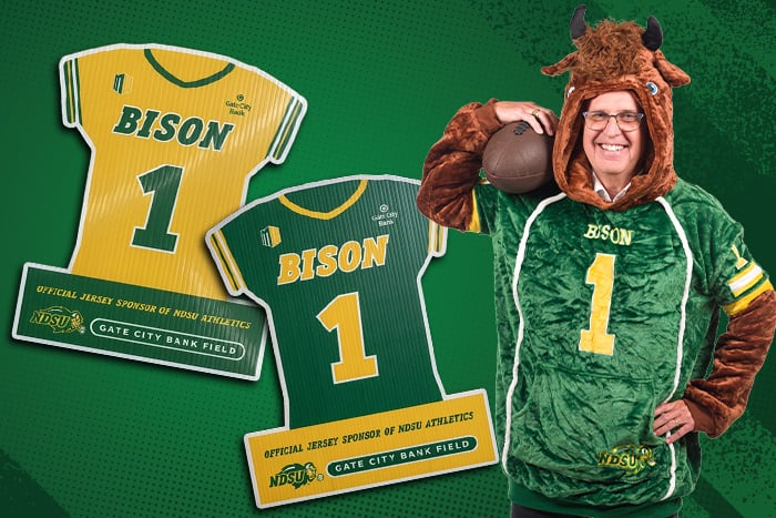 Gate City Bank President & CEO Kevin Hanson shows the Snugible and yard signs available at the Bank’s NDSU Homecoming Party.