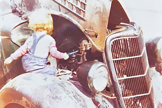 As a toddler, Kim Settel pretends to work on the engine of her father’s 1932 Ford Deuce Coupe