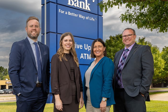 Mortgage lenders from Grand Forks and Devils Lake, ND, stand outside the Gate City Bank location in Grand Forks.