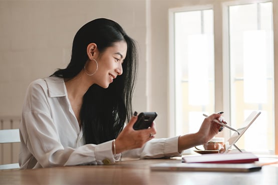 young woman balances checkbook with calculator